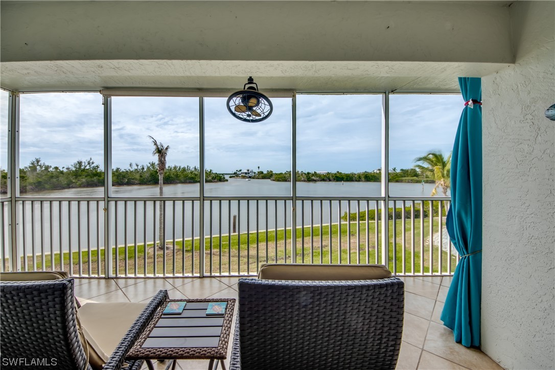 16611 Stringfellow Road, Unit 203 Bokeelia, FL 33922 - Photo 32 of 48 a view of a balcony with wooden floor