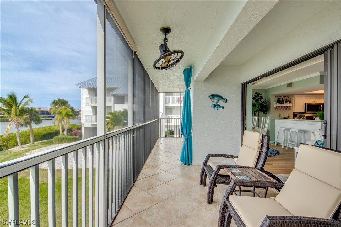 16611 Stringfellow Road, Unit 203 Bokeelia, FL 33922 - Photo 36 of 48 a view of a chairs and table in a balcony