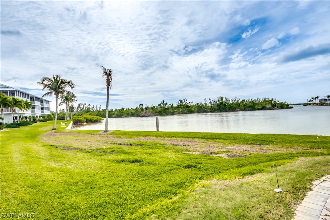 16611 Stringfellow Road, Unit 203 Bokeelia, FL 33922 - Photo 39 of 48 a view of a lake with houses in the back