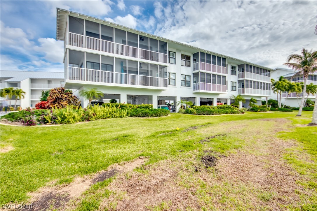 16611 Stringfellow Road, Unit 203 Bokeelia, FL 33922 - Photo 40 of 48 a front view of building with yard