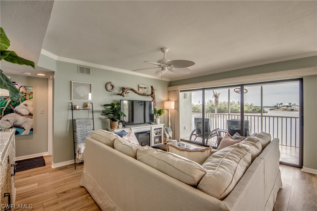 16611 Stringfellow Road, Unit 203 Bokeelia, FL 33922 - Photo 4 of 48 a living room with furniture and a large window