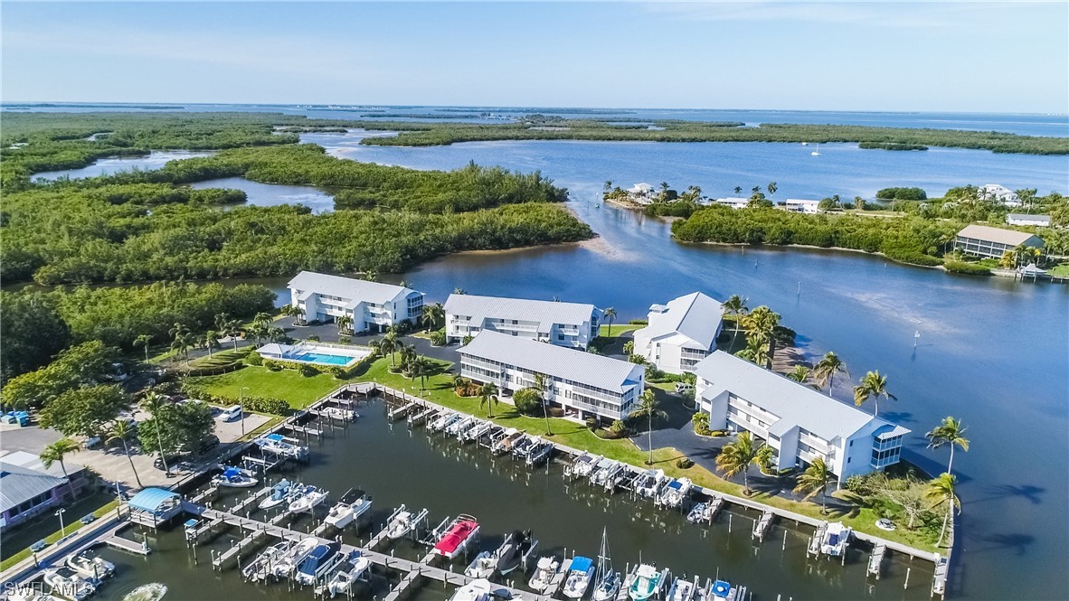 16611 Stringfellow Road, Unit 203 Bokeelia, FL 33922 - Photo 48 of 48 an aerial view of a house with a garden and lake view