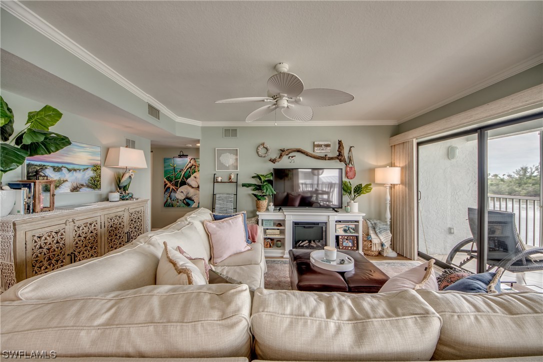 16611 Stringfellow Road, Unit 203 Bokeelia, FL 33922 - Photo 5 of 48 a living room with furniture and a flat screen tv