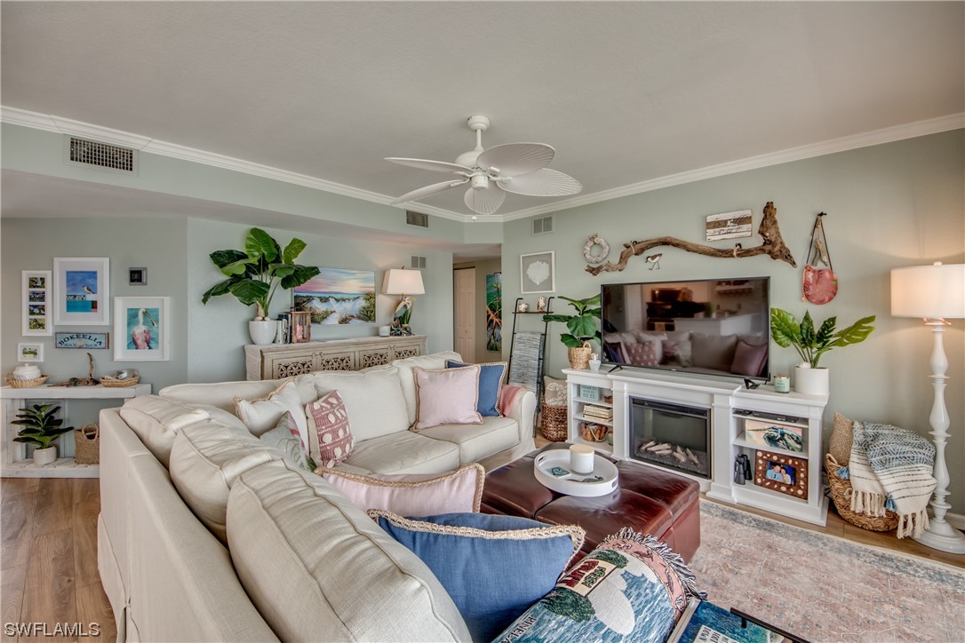 16611 Stringfellow Road, Unit 203 Bokeelia, FL 33922 - Photo 6 of 48 a living room with furniture fireplace and a flat screen tv