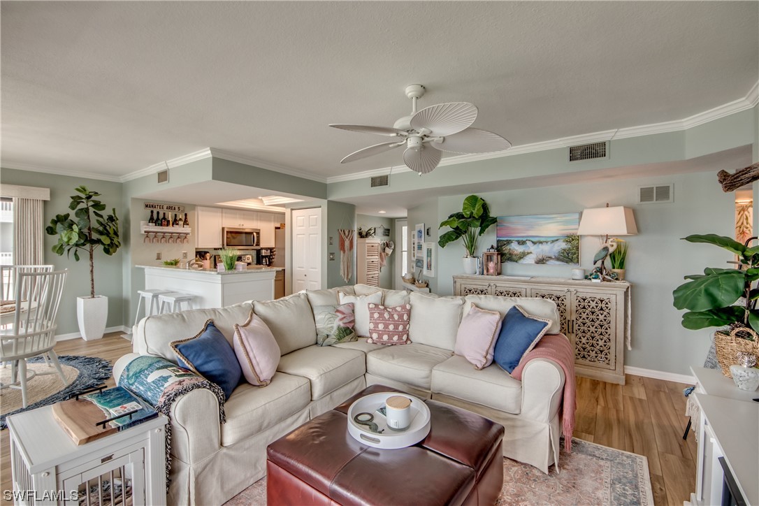 16611 Stringfellow Road, Unit 203 Bokeelia, FL 33922 - Photo 7 of 48 a living room with furniture a fireplace and a potted plant
