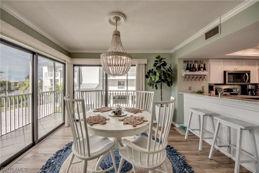 16611 Stringfellow Road, Unit 203 Bokeelia, FL 33922 - Photo 8 of 48 a view of a dining room with furniture window and outside view