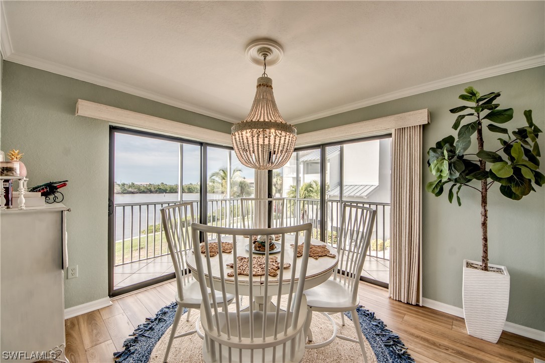16611 Stringfellow Road, Unit 203 Bokeelia, FL 33922 - Photo 9 of 48 a view of a dining room with furniture window and outside view