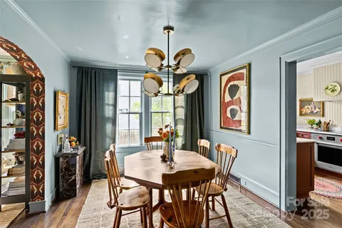 a view of a dining room with furniture and chandelier