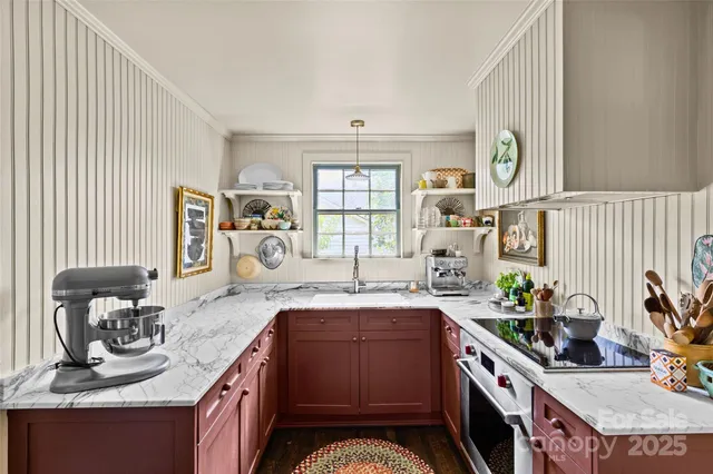 a kitchen with furniture and a refrigerator