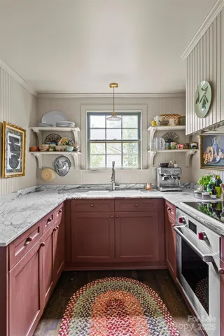 a kitchen with a sink cabinets and window