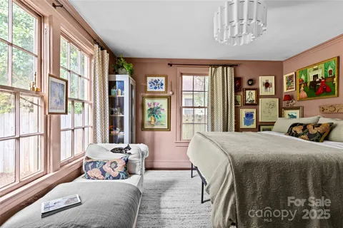 a bedroom with a large bed and a large window
