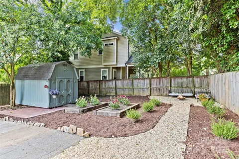 a front view of a house having plants
