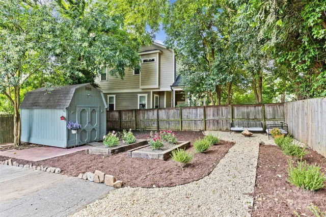 a front view of a house having plants