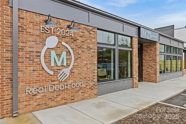 a sign that is sitting in front of a house