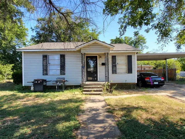 a view of a house with backyard porch and sitting area