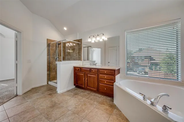 a large bathroom with a large tub shower and sink