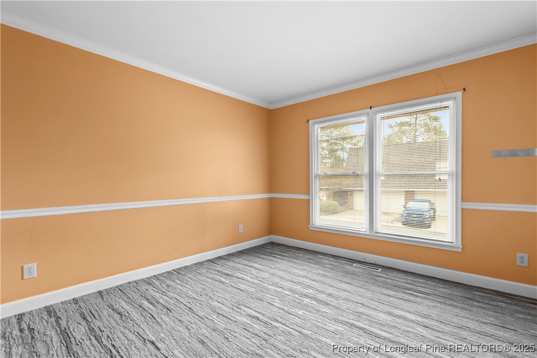 124 Racquet Lane Pinehurst, NC 28374 - Photo 15 of 25 an empty room with wooden floor and windows