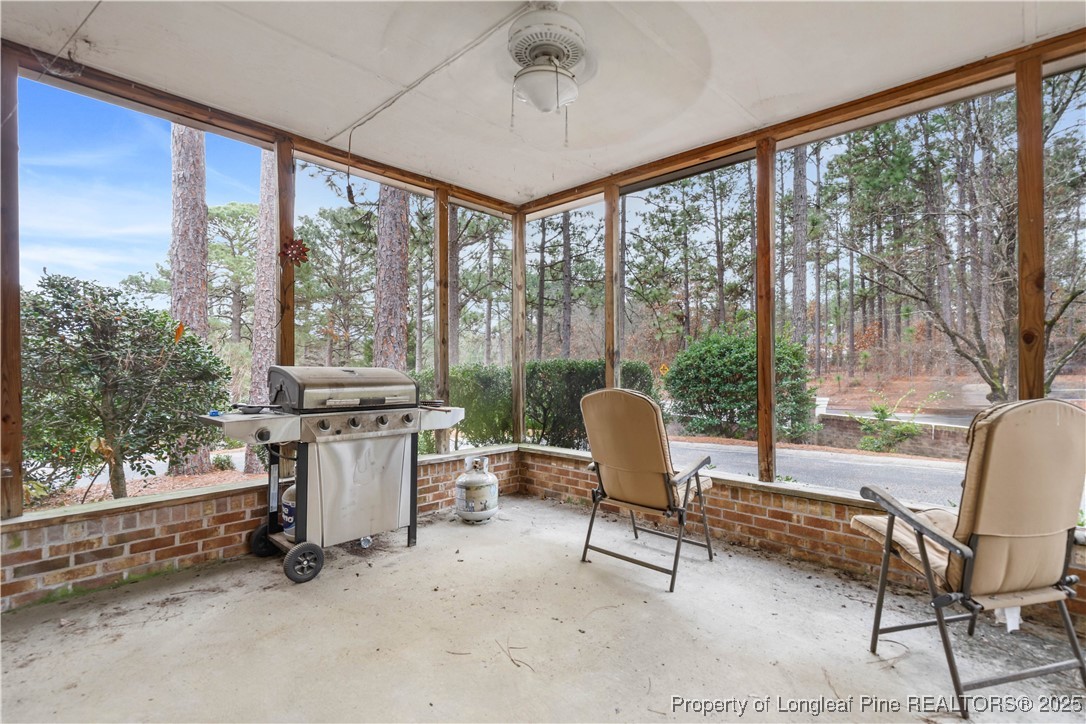 124 Racquet Lane Pinehurst, NC 28374 - Photo 22 of 25 a living room with furniture and a floor to ceiling window