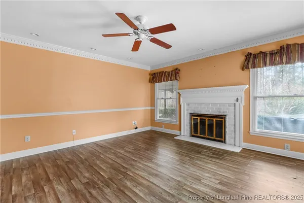 wooden floor in an empty room with a fireplace