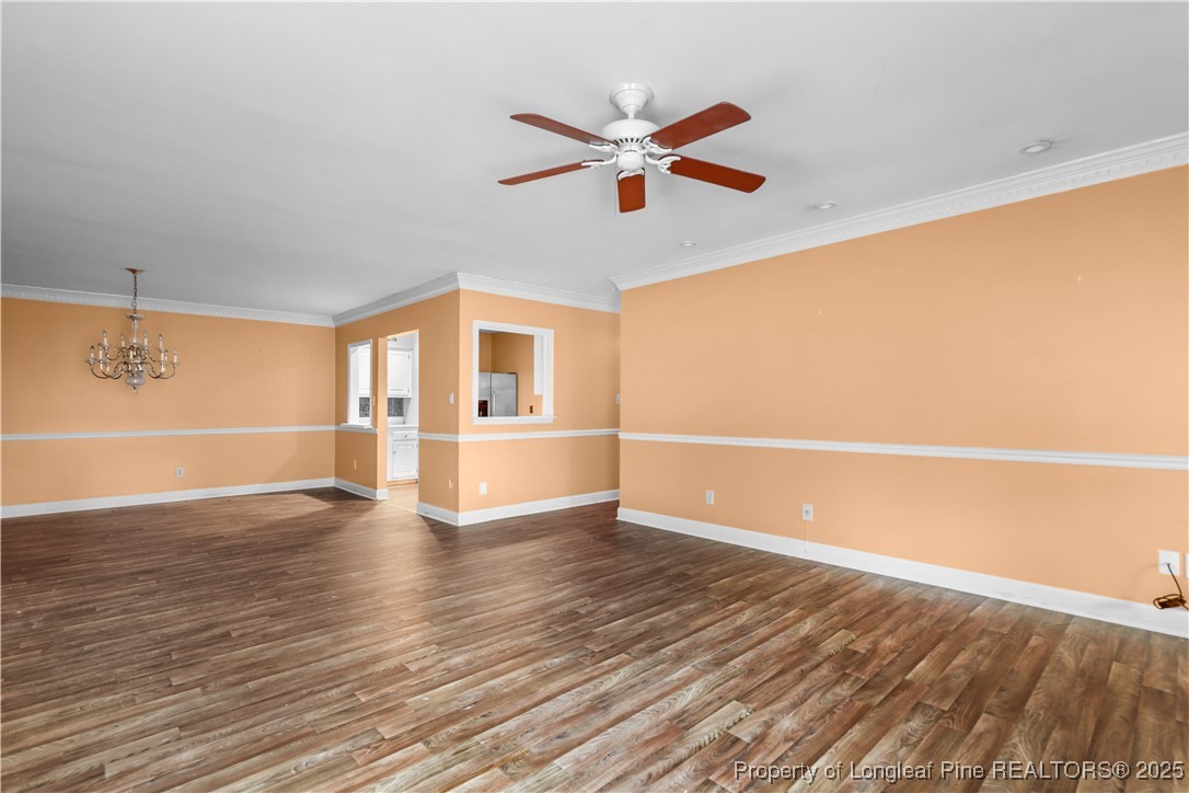 124 Racquet Lane Pinehurst, NC 28374 - Photo 4 of 25 a view of empty room with wooden floor and fan