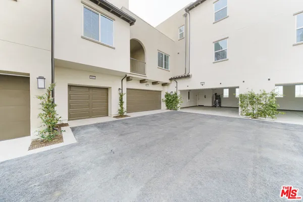 a view of a white house with a garage