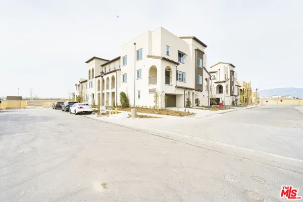 a view of a street with a building in the background