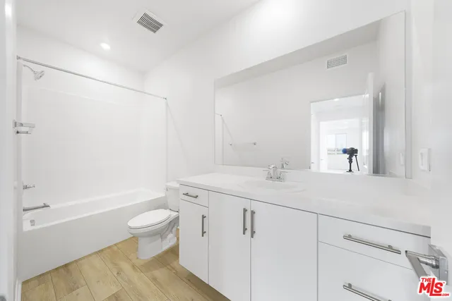 a bathroom with a sink a toilet and a bathtub