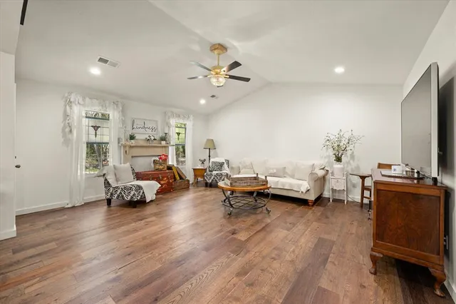 a living room with furniture and a floor to ceiling window