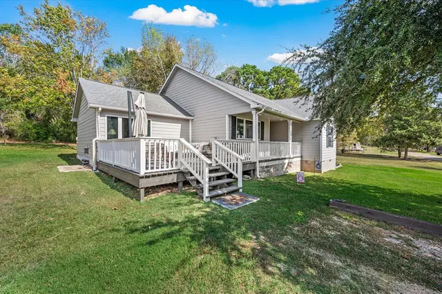 a view of a house with a backyard and a patio