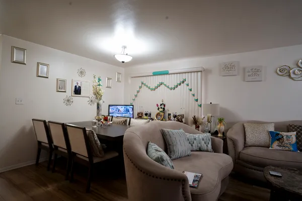 a living room with furniture and a wooden floor