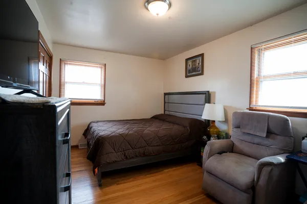 a bedroom with a bed couch and window