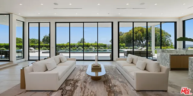 a view of outdoor space with swimming pool and trees in the background