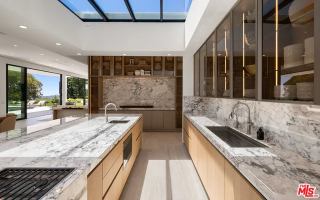 a bathroom with a granite countertop sink and a large mirror