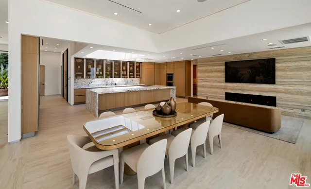 a dining room with furniture and a floor to ceiling window