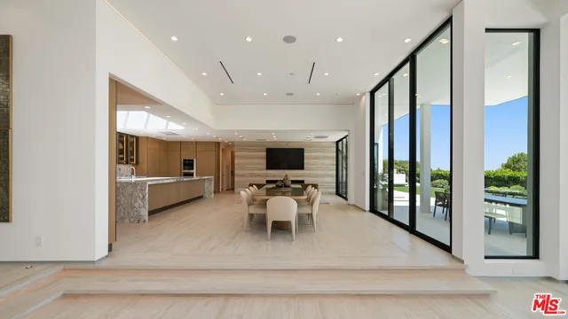 a very nice looking living room with a large window and a flat screen tv