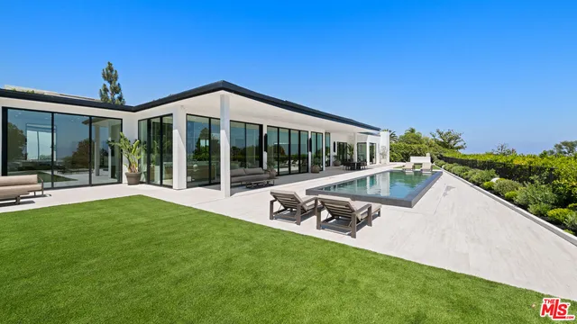 a view of a house with backyard sitting area and garden