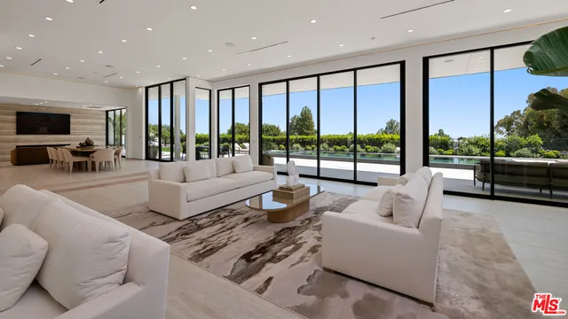a living room with furniture large window and flat screen tv
