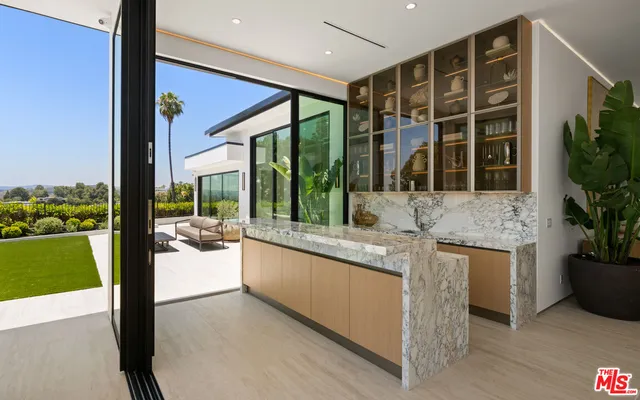 a living room with couch and large windows