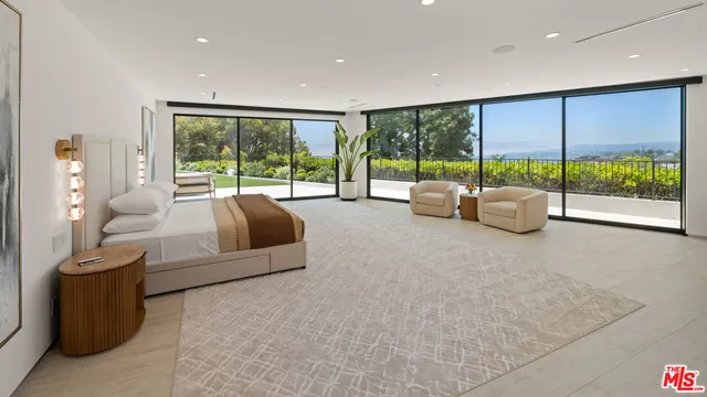 a living room with furniture and large windows