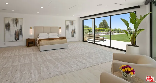 a spacious bedroom with a large bed and a large window