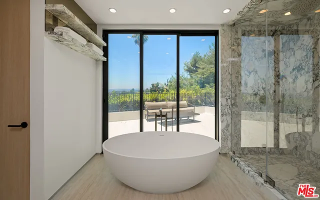 a spacious bedroom with a bed and a large window