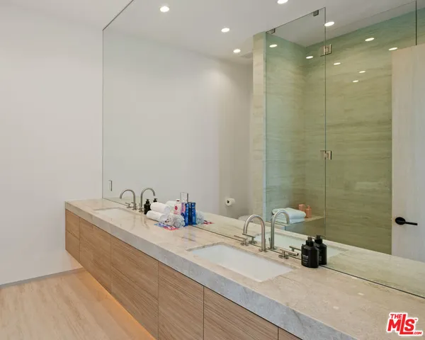 a bedroom with a bed and a night stand