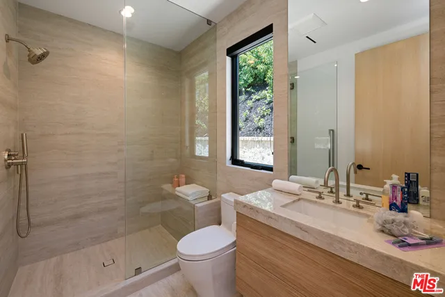 a bedroom with furniture and a flat screen tv