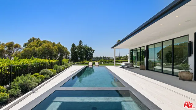 a view of balcony with wooden floor and outdoor seating