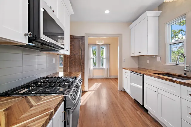 a kitchen with sink a stove and cabinets