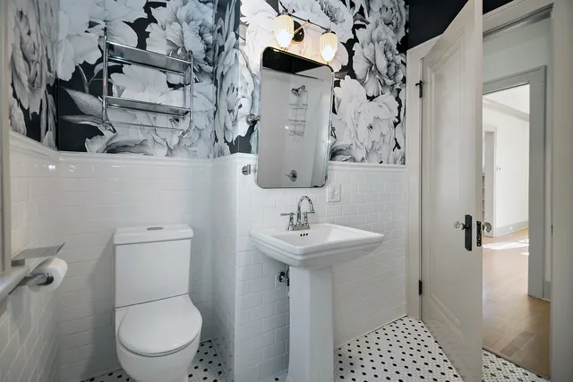 a bathroom with a toilet sink and shower