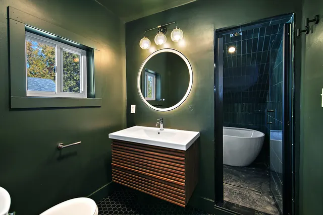 a bathroom with a sink mirror and toilet
