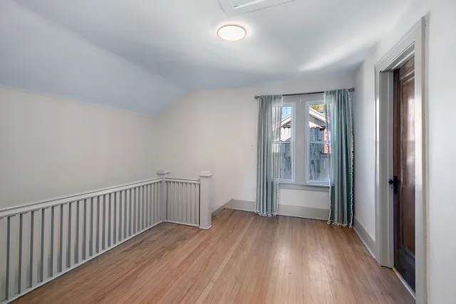 a view of hallway with wooden floor