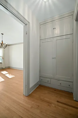 a view of empty room with wooden floor