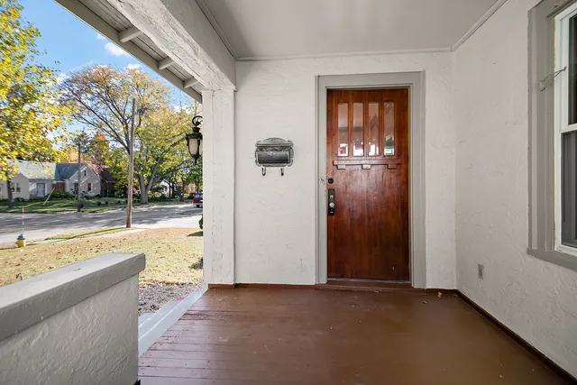 an empty room with sliding door and wooden floor